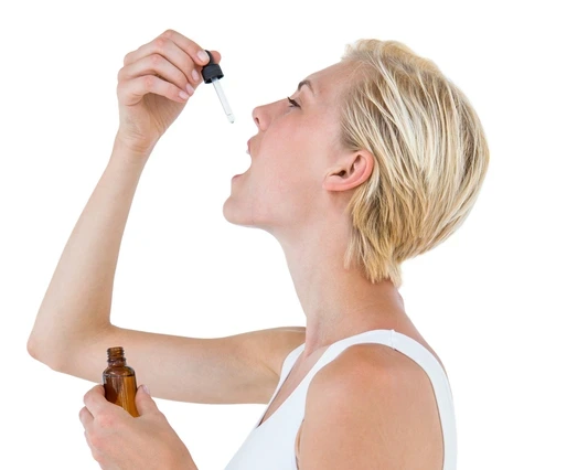 woman properly dosing full spectrum hemp oil product